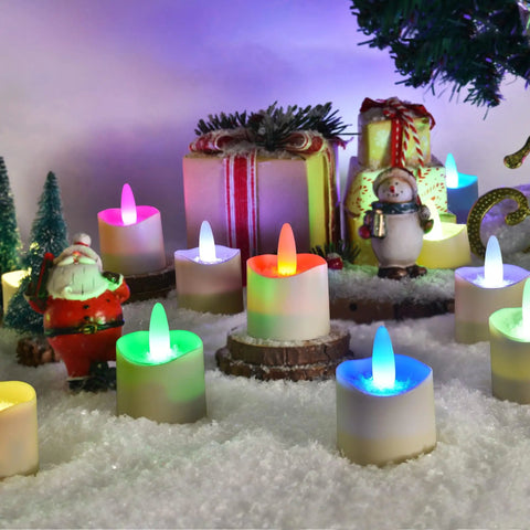 Flameless LED Candles With Remote Timer And Charging Station For Outdoor Use Rechargeable Waterproof RGB Tea Lights Delivering 60 Plus Hours Of Glow Colorful Candles For Valentines Day Halloween Christmas Home Party Decor 12 Pieces in a snowy festive setting with gift boxes and figurines.