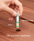 Hand holding stainless steel quick bench dog pin for MFT tables, showing precise hole alignment and CNC machining details.
