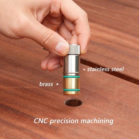 Hand holding stainless steel quick bench dog pin for MFT tables, showing precise hole alignment and CNC machining details.