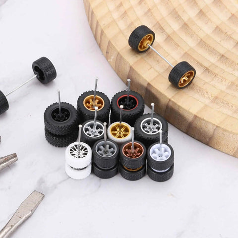 Four Pack One Sixty Fourth Scale Wheels And Tires Set With Real Riders Rims In White With Gold Seven Spoke Design Includes Axles