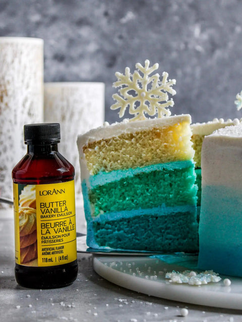 Bakery Emulsion Variety Pack For Cakes, Cookies And Desserts With Flavors Almond, Butter Vanilla, Lemon, Princess Cake And Cookie, Red Velvet, Strawberry Gluten Free And Keto Friendly, 4 Oz Bottles A Must Have For Home Bakers next to blue layered cake with snowflake topper