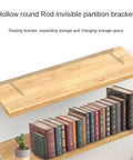 Hollow round Rod invisible partition bracket with wood shelves and books on display for clean modern decor.