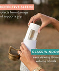 Ultra Wide Neck Glass Breast Milk Storage Bottles For Pumping And Feeding Bpa Free Silicone Caps Fit Most Pumps Aspen White Pair, showing protective sleeve and glass window for volume viewing.