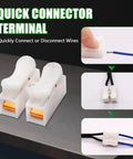 Quick connector terminal for easy wire connection and disconnection, showing a pair of white plastic connectors on a grey surface.