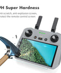 2 Pack HD Tempered Glass Screen Protector For DJI RC Pro Mini 3 Pro Mini 4 Mavic 3 Pro Air 3S Mavic 4 Pro Drone Remote Controller Shield Guard 9H Hardness Ultra Clear High Touch Sensitivity Scratch Resistant Easy Install shown with a hammer on a drone controller screen