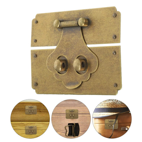 Close-up of vintage brass hasp latch buckle with gold antique look for jewelry boxes and retro wooden cases, installed on wood.