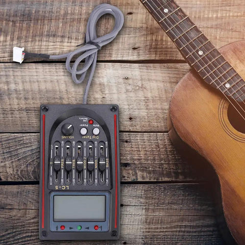 Five Band Acoustic Guitar Preamp With LCD Display Piezo Pickup LC-5 Equalizer Tuner And Mic Input next to guitar on wooden surface
