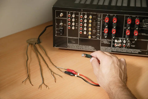 Hand using Electrical Troubleshooting Kit For Home And Commercial Use, 3-In-1 Circuit Breaker Finder, GFCI Tester, Voltage Detector on wires