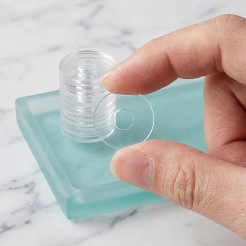 Clear PVC Shower Door Washer Replacement Kit 100 Pack Round Antiscratch Glass Protectors For Handles And Towel Bars Perfect For Glass Door Repair And Towel Bar Replacement Keeps Showers Looking Slick And Leak Free. clear round washer held by hand