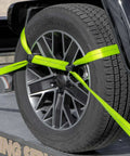 Close-up of neon webbing securing car tire with Eight Point Vehicle Tie Down Kit With Snap Hook Ends And Chain Tail On Ratchet Ends.