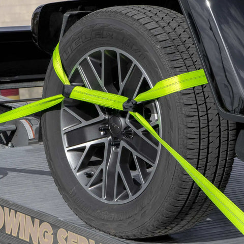 Close-up of neon webbing securing car tire with Eight Point Vehicle Tie Down Kit With Snap Hook Ends And Chain Tail On Ratchet Ends.