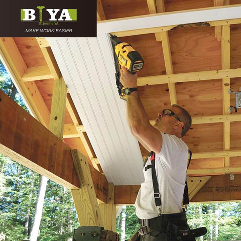 Person using a nail gun on wooden beams under construction with a visible BIYA logo in the top left corner.