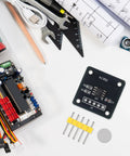 Two Pack MT6701 Magnetic Encoder Module For Angle Measurement, tools, and components on a white surface, ready for robotics projects.