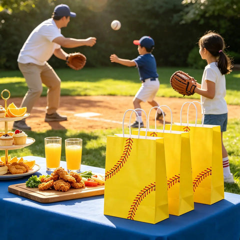 Softball Themed Paper Goodie Bags With Handles 12 Pack for Party Favors on picnic table, kids playing softball in background.