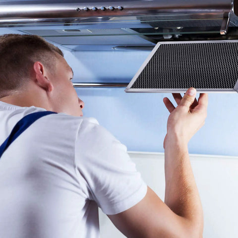 Person installing 3 Pack Range Hood Filter Replacement 8.7 X 10.5 Inch Aluminum Charcoal Combo Filter in kitchen
