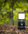 Compact Siege AA 200-Lumen Lantern With White And Red LEDs For Camping And Emergencies on a forest floor