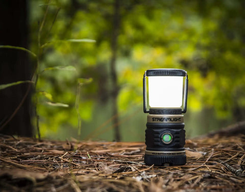 Compact Siege AA 200-Lumen Lantern With White And Red LEDs For Camping And Emergencies on a forest floor
