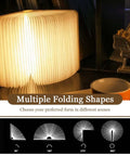 Wooden Folding Mood Light Book Lamp with USB Rechargeable Battery displaying multiple folding shapes on table