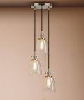 Three Light Industrial Pendant Lighting With Clear Glass Pendants For Kitchen Island And Dining Room, Brushed Steel Finish, Vintage Modern Style Hanging Lamps For Home, Bar Or Cafe, 120V Compatible showing all three lights with clear glass shades from a side angle.