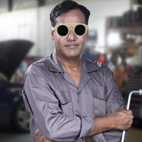 Man wearing badass adjustable welding glasses with anti scratch lenses for safe industrial eye protection in a workshop.
