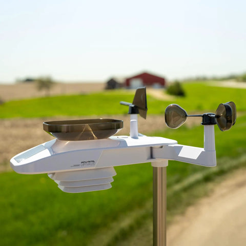 Optimus Weather Station With WiFi HD Display Solar Power Pack Lightning Detection Indoor Outdoor Temperature And Humidity Wind Speed And Direction Rainfall Measurements For Hyperlocal Readings installed in a rural setting.