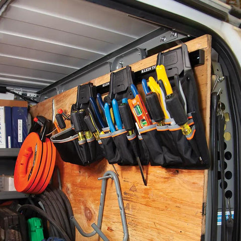 Tradesman Pro Modular Drill Pouch With Belt Clip for Click Lock System on van wall rack, holding tools upright and accessible.