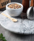 12 Inch Solid Marble Lazy Susan Turntable With Buttery Smooth Swivel Base For Zero Fuss Kitchen Countertop Organization with spices.