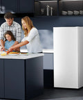 Family cooking in a modern kitchen near the No Fuss Compact Upright Freezer With Six Cubic Feet Capacity.