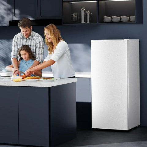 Family cooking in a modern kitchen near the No Fuss Compact Upright Freezer With Six Cubic Feet Capacity.