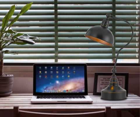 Industrial Downbridge Floor Lamp With Adjustable Head And Arm Heavy Metal Build next to laptop on wooden desk in living room