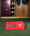 Rugged Outdoor Fire Extinguisher Cover With Quick Install Mount And Inspection Tag Pocket, shown indoors on green carpet