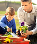 Child using Heavy Duty Cast Aluminum Garden Hand Shovel And Trowel For Planting Transplanting Weeding And Digging Soil with adult guidance