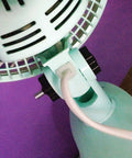 Close-up of a fan with a Star Shaped Knurled M8 Grippy Clamping Knobs Black Plastic Screw On Type visible near the base.