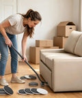 Woman using ergonomic tool with Super Easy Heavy Furniture Sliding Kit With Eight Premium Moving Pads under sofa for moving.