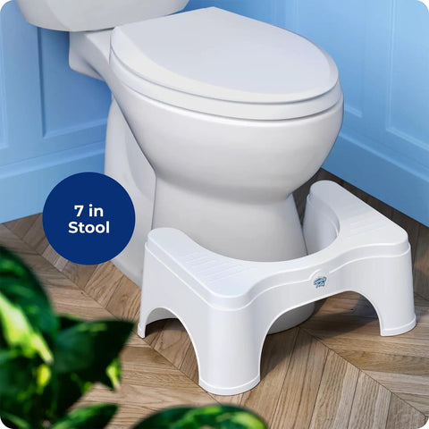 Toilet Stool 2.0 Base 7 Inch White for Natural Elimination placed in front of a toilet on tiled floor