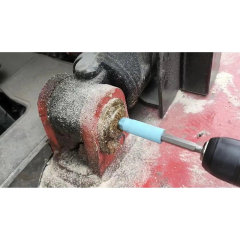 Using grease zerk cleaner kit for grease fittings with four color cleaners and one zerk fitting on machinery part.