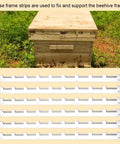 Metal Beehive Frame Spacers 24 Piece 4 Set Beehive Box Spacing Tool For Beekeeping Equipment next to wooden beehive in garden