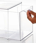 Hand pulling out clear drawer of Stackable Closet Storage Bins With Pull Out Drawers Clear Plastic Shoes And Small Item Organizer For Cabinets Desks Shelves And Dressers Lumiere Collection Space Saver 2 Pack