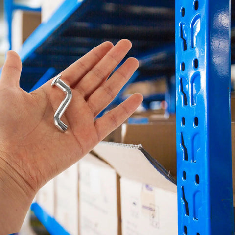 Person holding Heavy Duty Metal Safety Latch Pin for Pallet Racks and Shelving Systems next to blue shelving