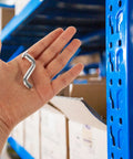 Heavy Duty Metal Pallet Rack Drop Pin Safety Clips for Shelving Systems in hand near blue rack post