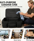 Man packing clothes into military grade rolling duffle bag