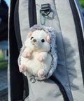 Stuffed hedgehog toy attached to a gray backpack using 8 Pack D Shape Carabiner Clips With Screw Gate, 2.2 Inch Aluminum Keychain Hooks