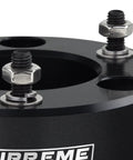 Close-up of T6 billet aluminum strut block for leveling kit, featuring adjustable bolts and a smooth finish.