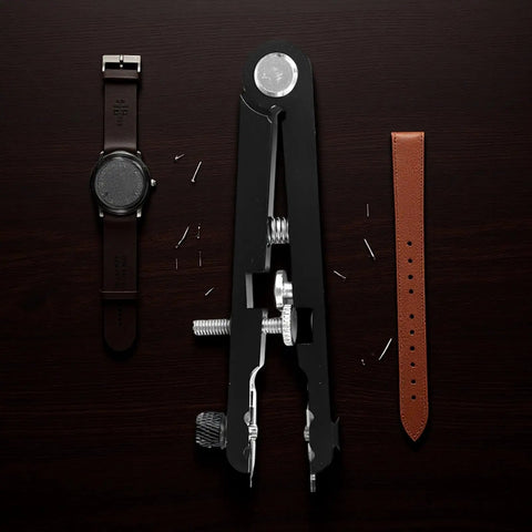 Pro Grade Watch Band Removal Tool Kit With 8 Pins, Heavy Duty Metal Spring Bar Tool, Black, with watch and band on wooden surface.