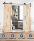 Double Sliding Barn Door Hardware Track Kit With Industrial Spoke Wheel Handle, installed in interior bathroom entrance.