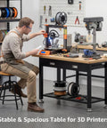 Man using Beast Heavy Duty Work Bench With Drawer And Storage For Garage And Shop, 2000 Lbs Steel Frame, Scratch Resistant Surface