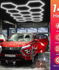 Hexagon LED Garage Lights Kit With 456W Output And 6500K Daylight, 14 Hex Panels Covering 4.1 By 2.4 M, lighting a red car in garage