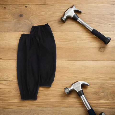 Black Waterproof Arm Sleeves Two Pack Heavy Duty Grease Shield For Mechanics And Construction Crews on wooden background with hammers.