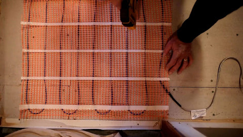 Keep Your Floors Toasty With This Electric Underfloor Heating Mat For Tile, Stone, Wood And Laminate 10 Sq Ft, 2 By 5 Feet, 120V, Easy Rollout Installation shown during installation.