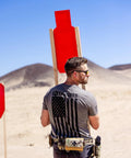 Man setting up 12x24 C Zone Self Healing Silhouette Target For Pistol And Rifle Training Indoor Or Outdoor Ranges Warm Color High Density